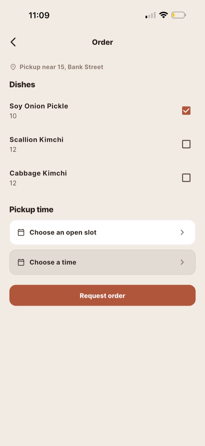 The order screen in Food(ie): tick the dishes you want, then choose one of the cook's open pickup slots.